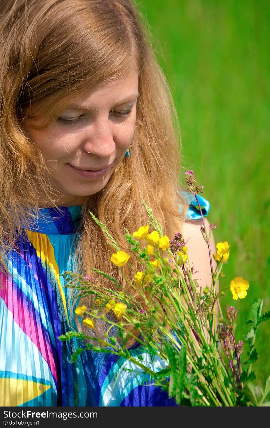 Young women in meadow with flowers