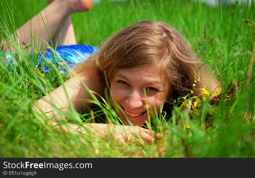 Young woman hiding in grass