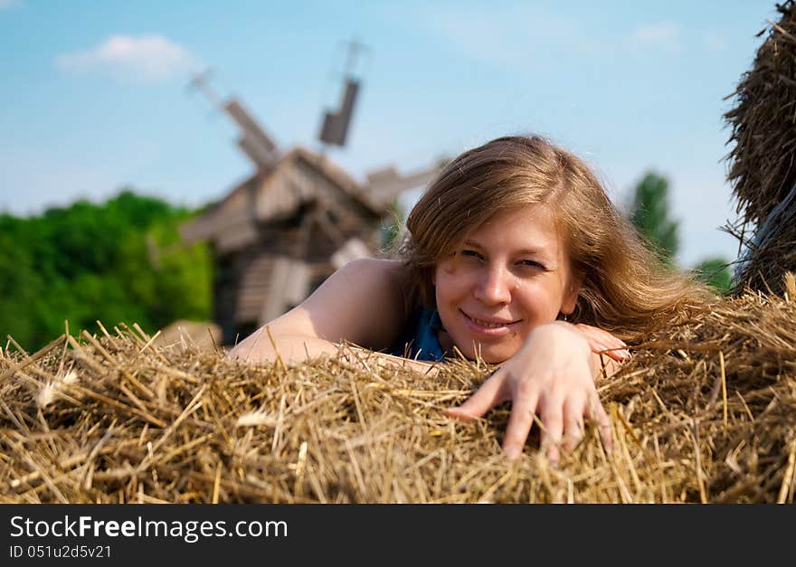 Young woman lying in straw. Young woman lying in straw