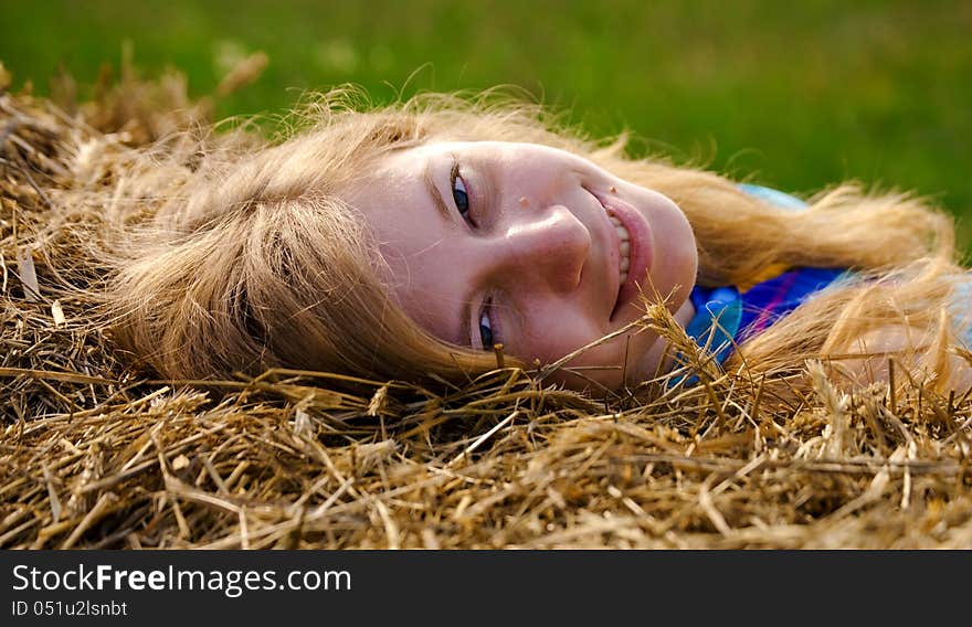 Young woman lying in straw. Young woman lying in straw