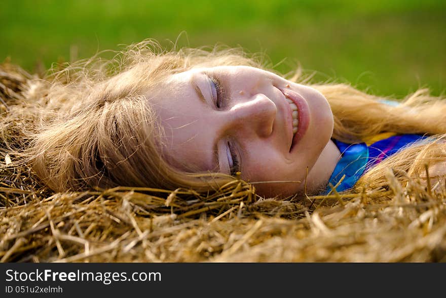 Young woman lying in straw. Young woman lying in straw