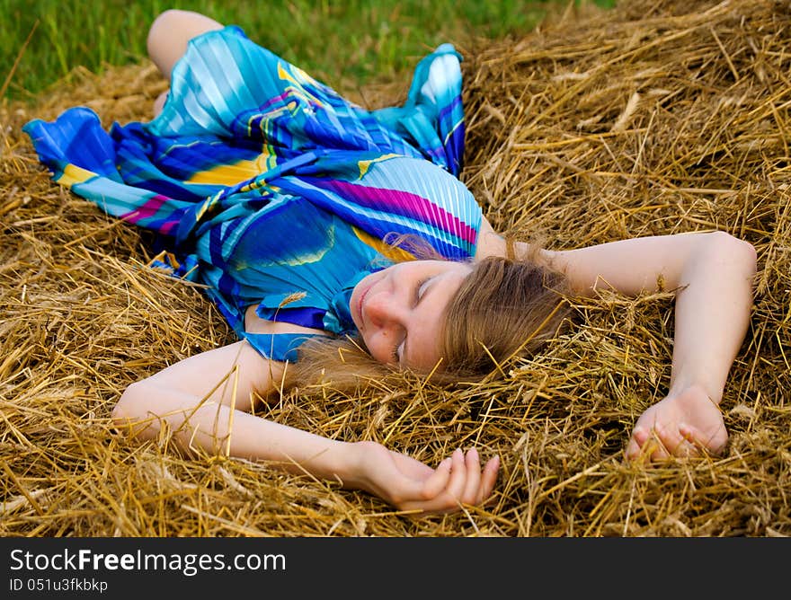 Young woman lying in straw. Young woman lying in straw