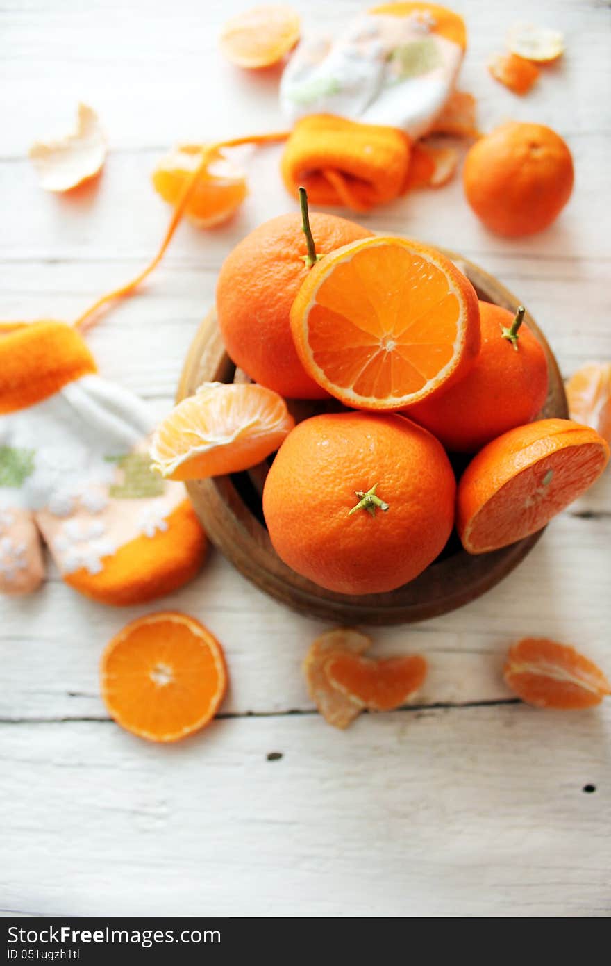 Photo of a bowl of oranges and gloves on background