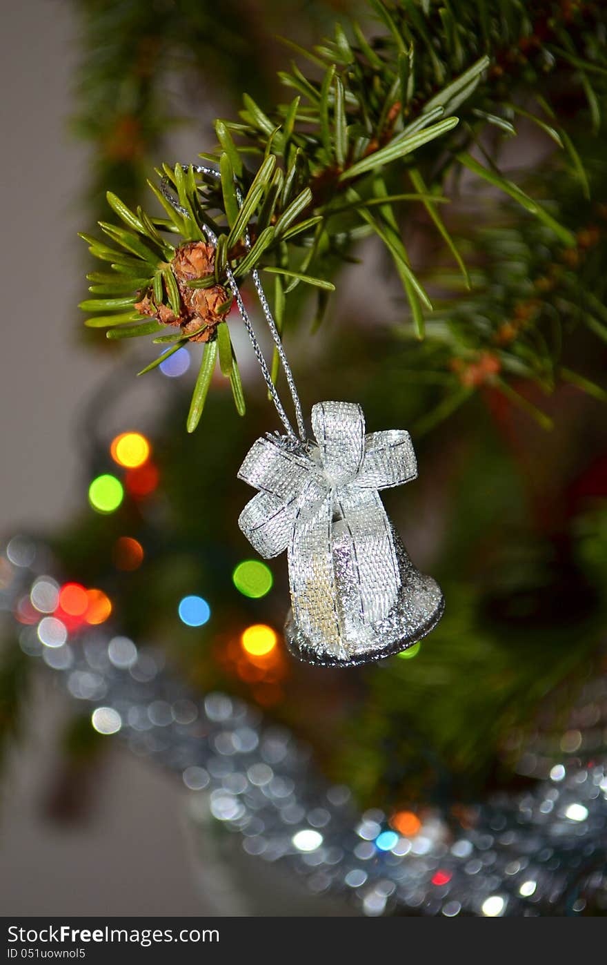 Image of a silver bell on a Christmas tree. Image of a silver bell on a Christmas tree