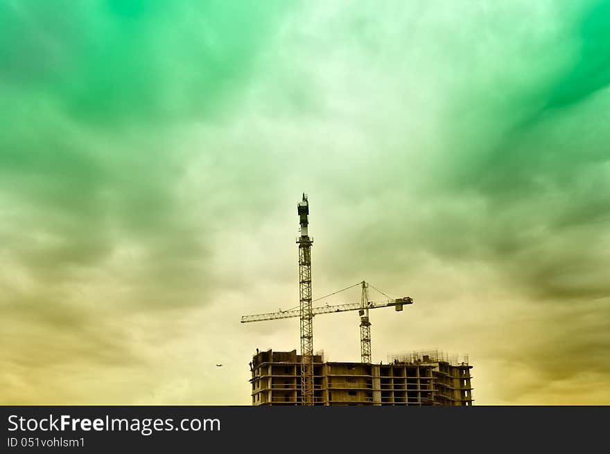 Construction site in a dusk with airplan on background