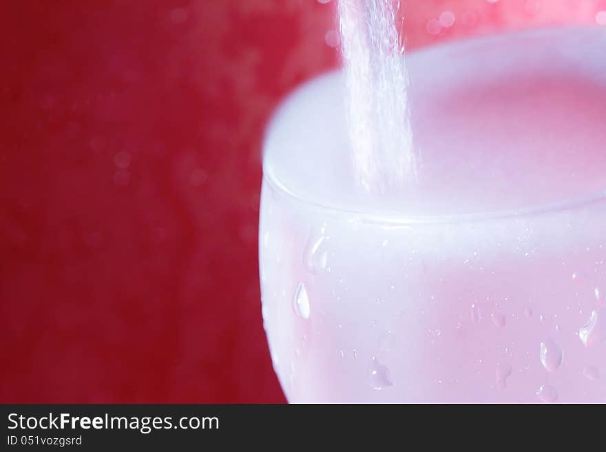 Pouring water on a red background