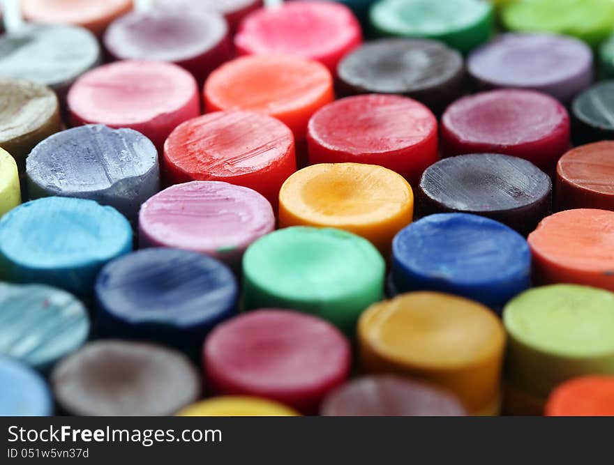 Back of colorful crayon pencils set together arranged to display their vivid and bright colors. Back of colorful crayon pencils set together arranged to display their vivid and bright colors