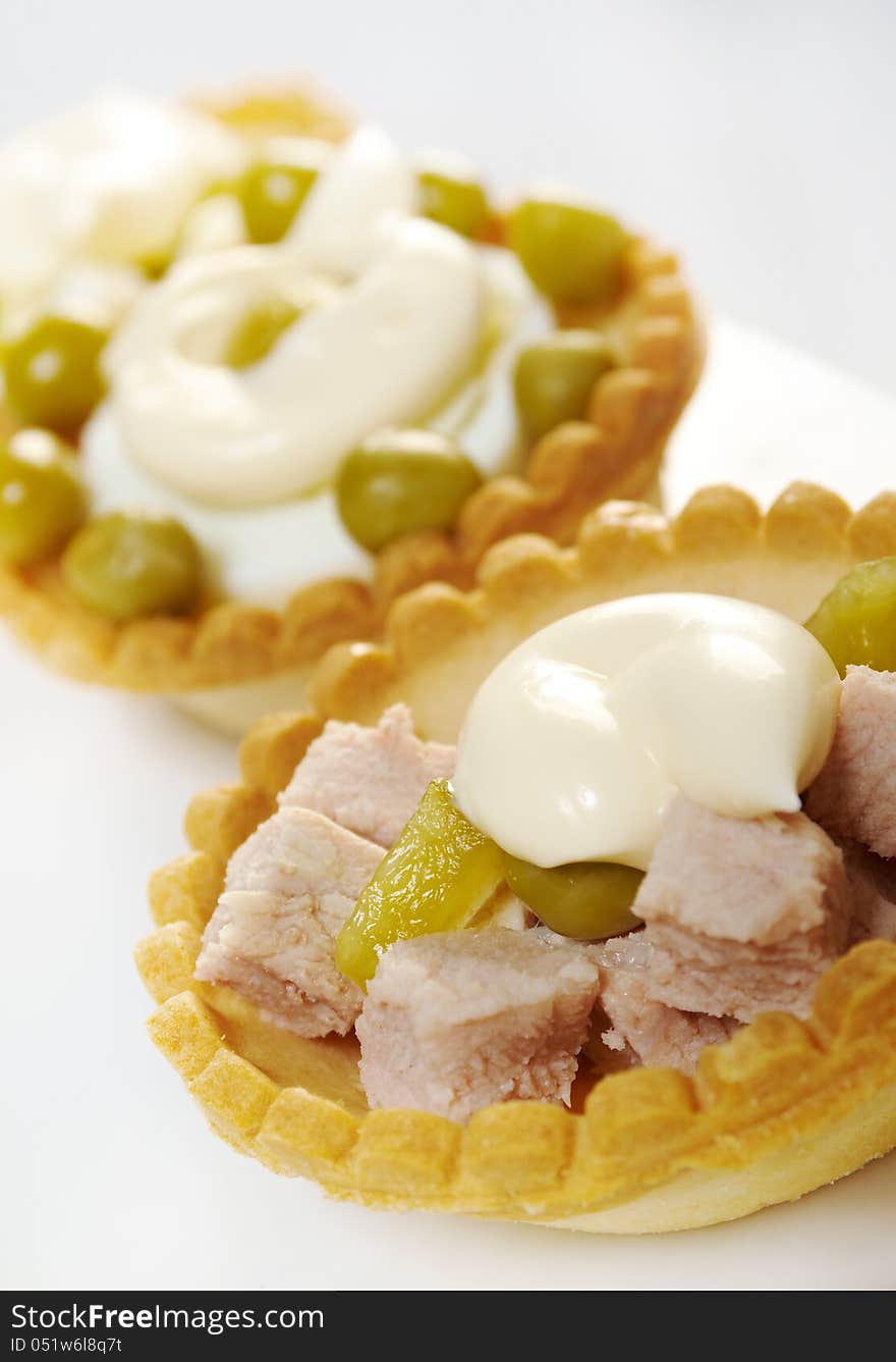 Tartlet with salad on a white plate .Shallow depth-of-field