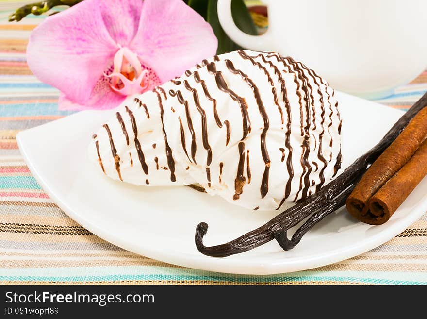 Striped marshmallow on a saucer with a vanilla, cinnamon