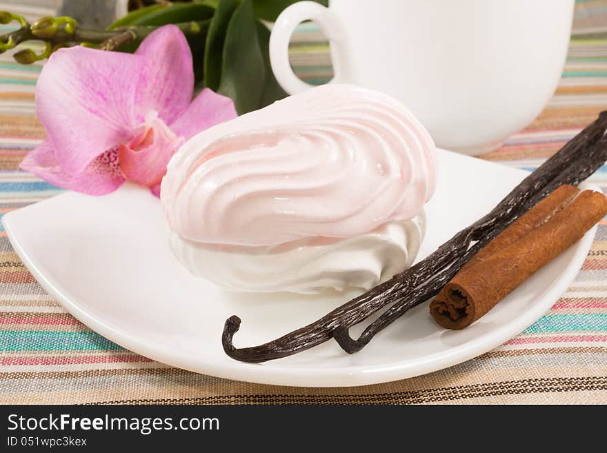 Pink marshmallow on a saucer with a vanilla, cinnamon