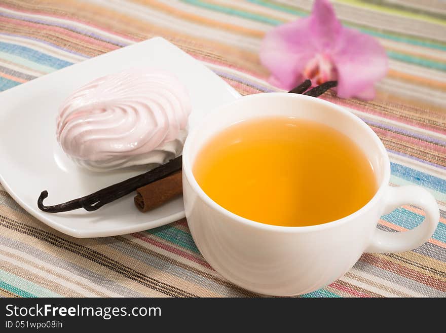 Cup Of Tea And Pink Marshmallow On A Saucer With A Vanilla