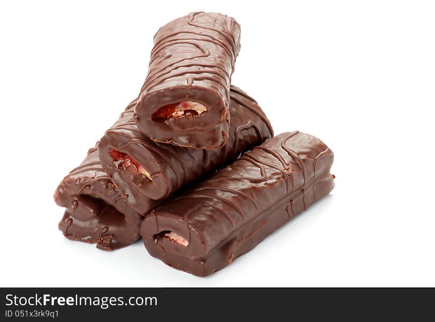 Stack of Delicious Swiss Rolls Stuffed Cream with Chocolate Glaze closeup on white background