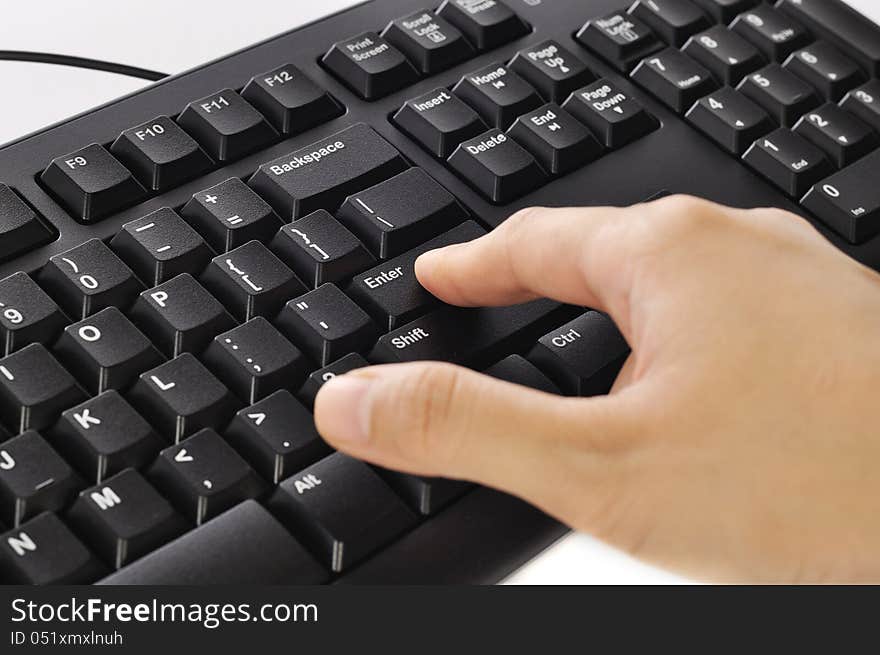 Woman hand typing on black computer keyboard over white background. Woman hand typing on black computer keyboard over white background