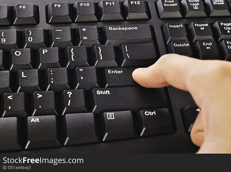 Woman hand typing on black computer keyboard over white background. Woman hand typing on black computer keyboard over white background