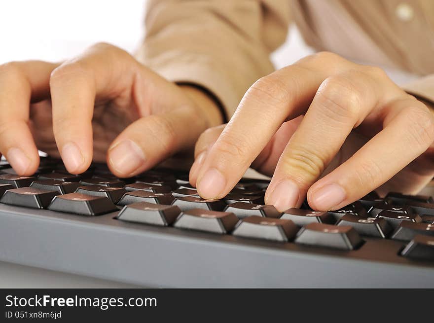 Woman hand typing on black computer keyboard over white background. Woman hand typing on black computer keyboard over white background