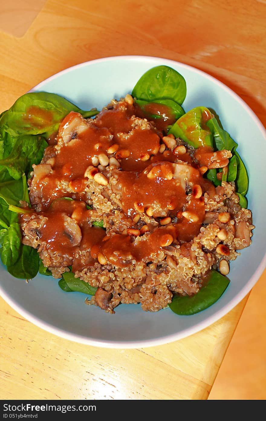 Tasty meal with groats, spinach and mashroom sauce on a blue pate