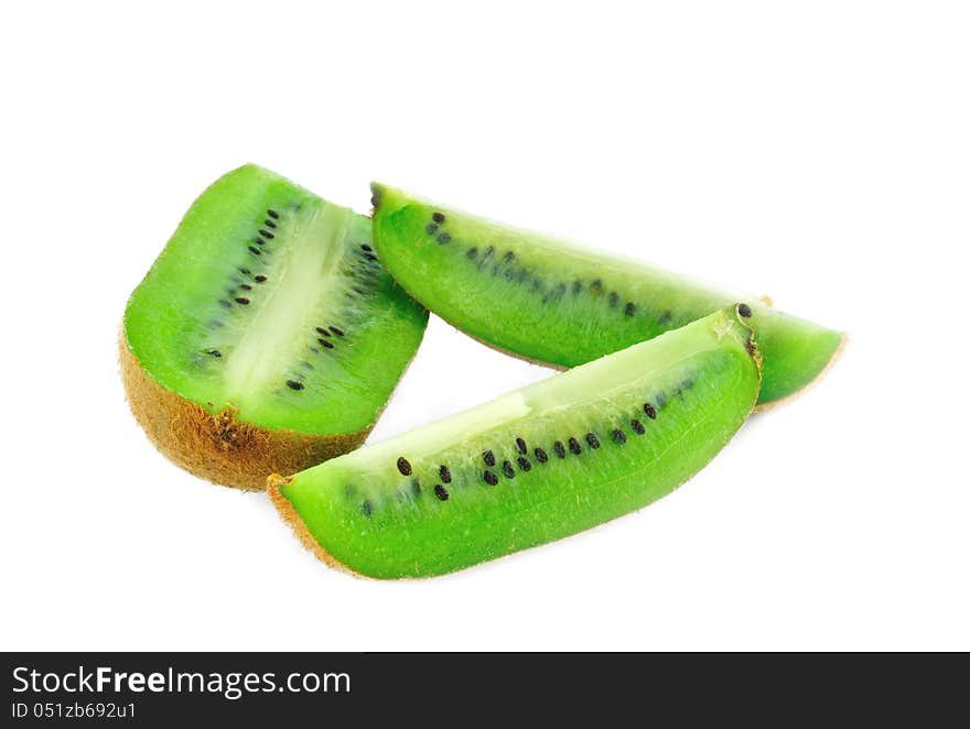 Kiwi fruit cut into three pieces photographed against a white background. Kiwi fruit cut into three pieces photographed against a white background