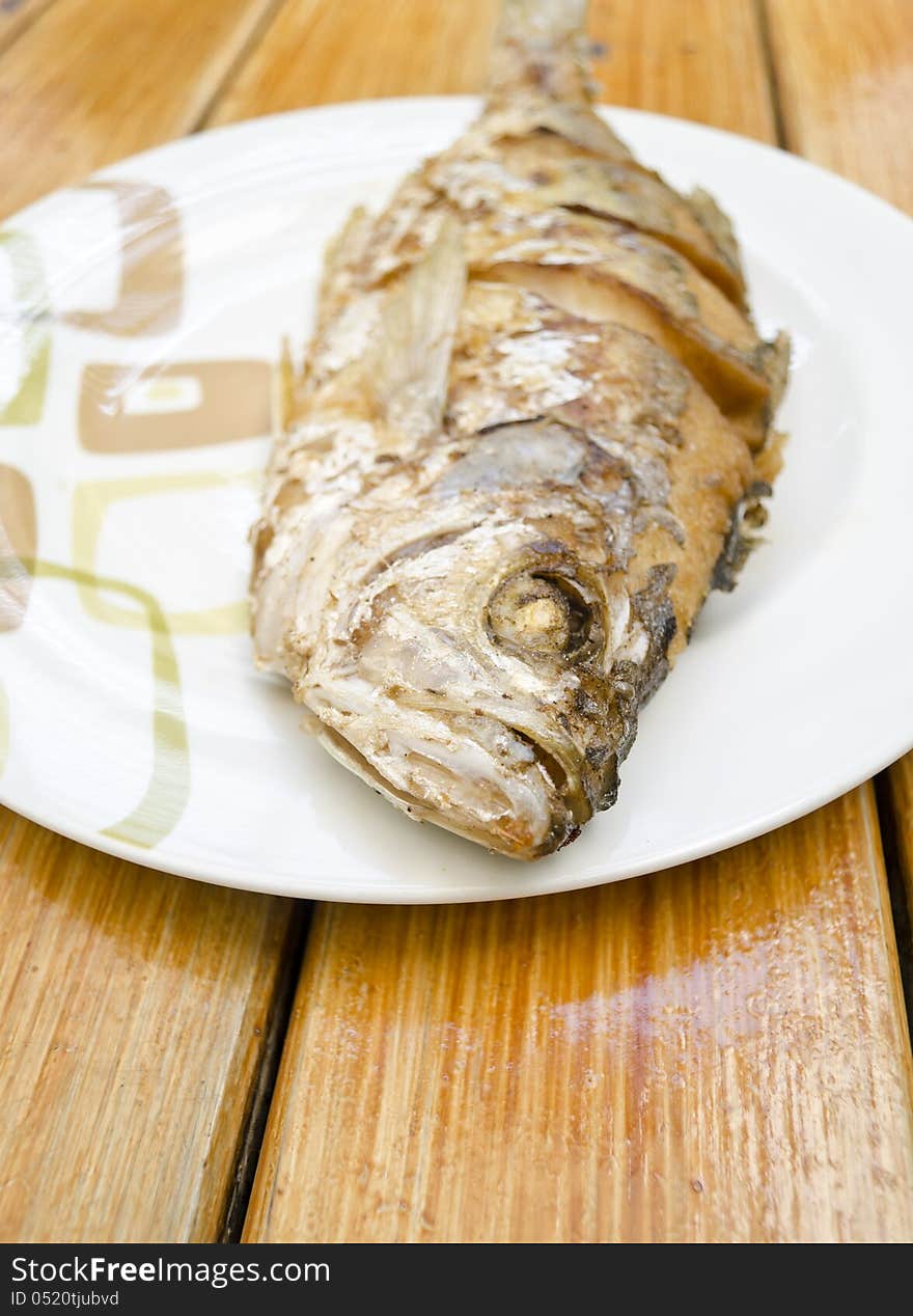 Fried fish on white dish, delicious thai food