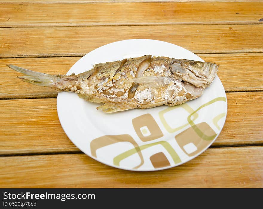 Fried fish on  wood background, delicious thai food