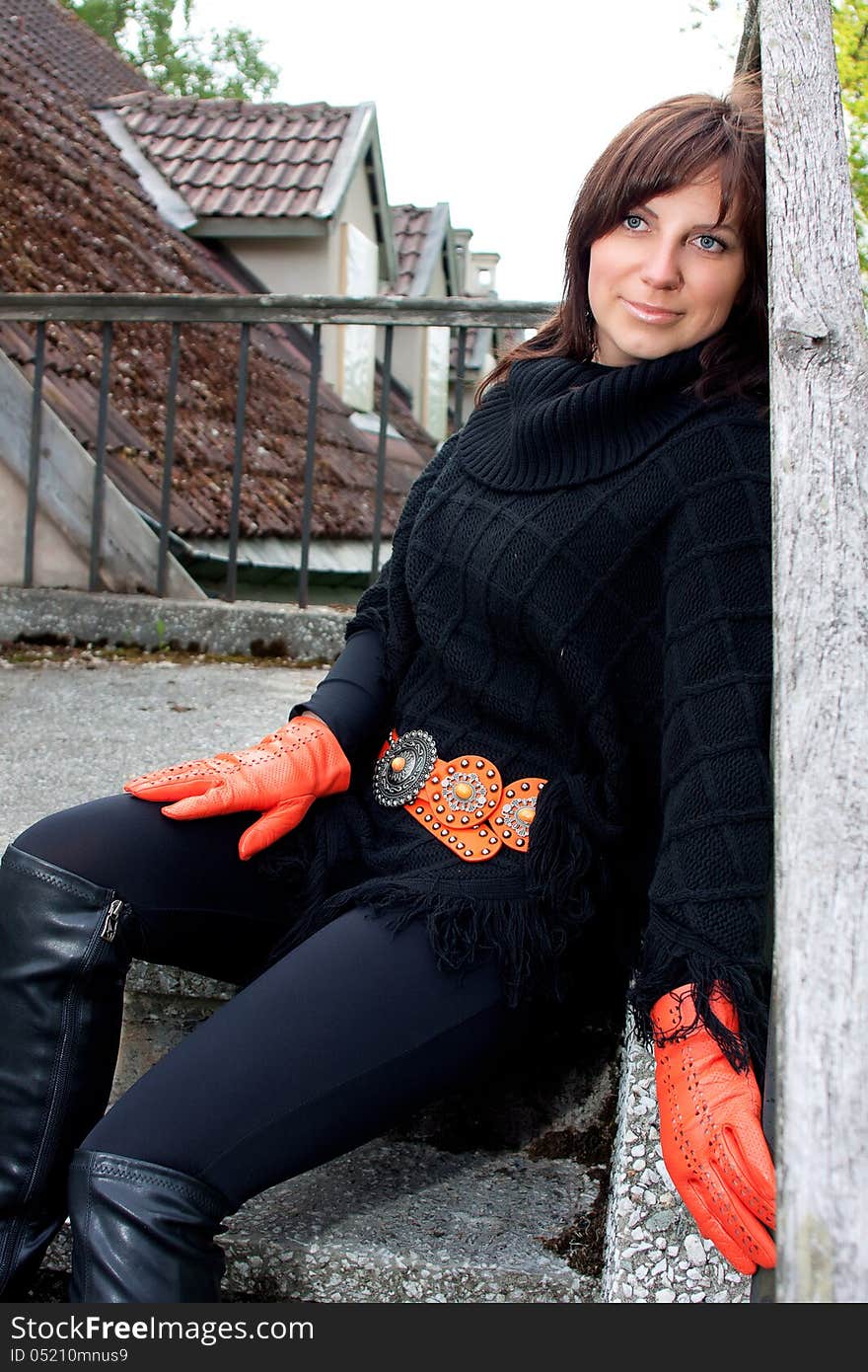 Beatiful smilling red gloved girl sitting on the stears. Beatiful smilling red gloved girl sitting on the stears