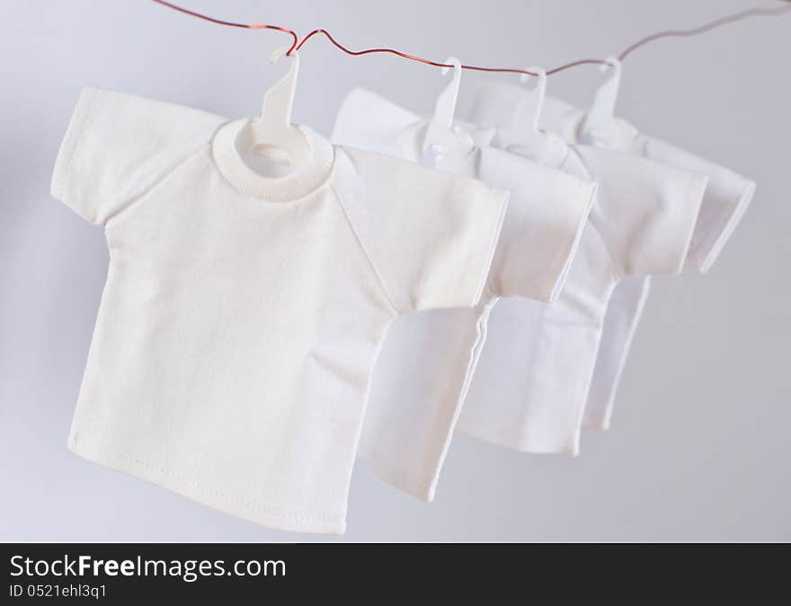 Dry white t-shirts with coat hanger isolated on white background