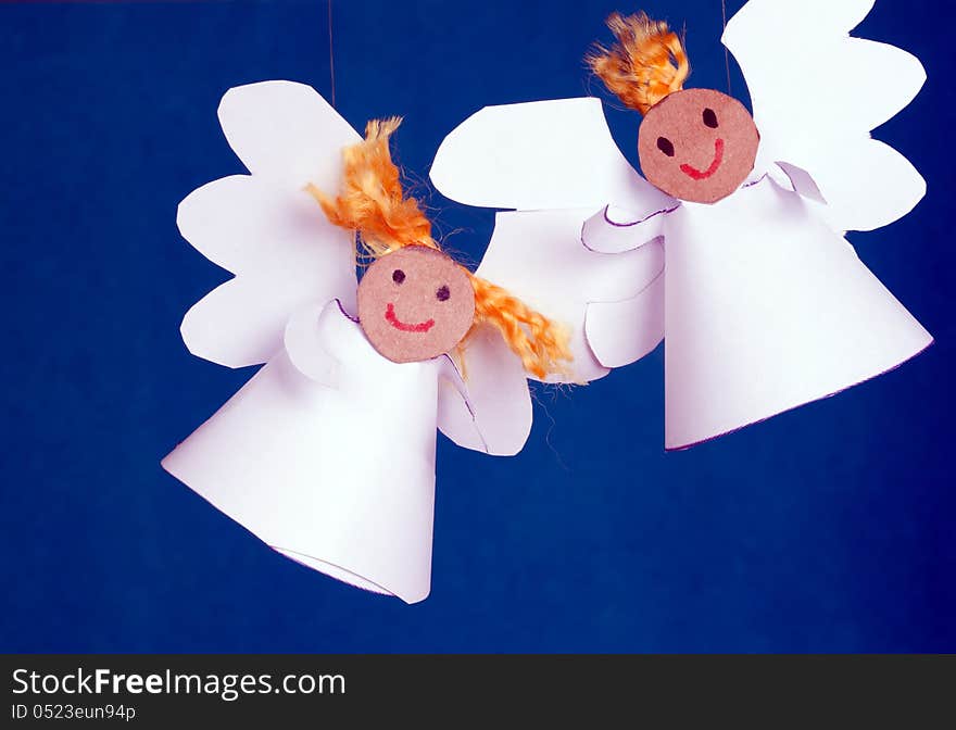 Two cheerful angels made from paper. Two cheerful angels made from paper.