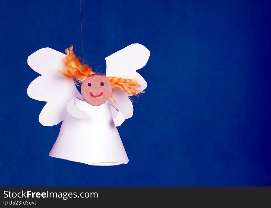 Funny paper angel girl on a blue background. Funny paper angel girl on a blue background