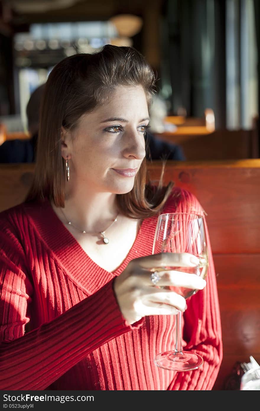 Portrait of a young woman with a glass of white wine. Portrait of a young woman with a glass of white wine.