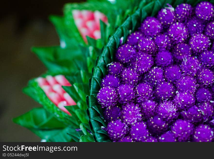 The viloet flowers with green leaf on a tray