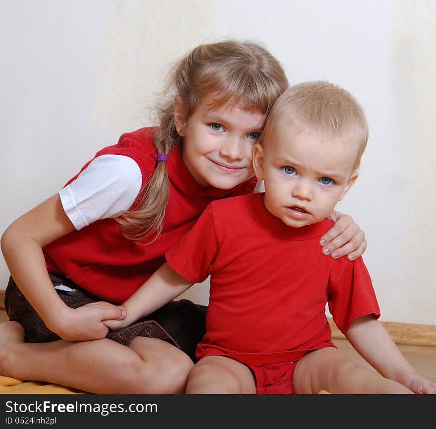 Shooting at home. Brother and sister in red. Shooting at home. Brother and sister in red