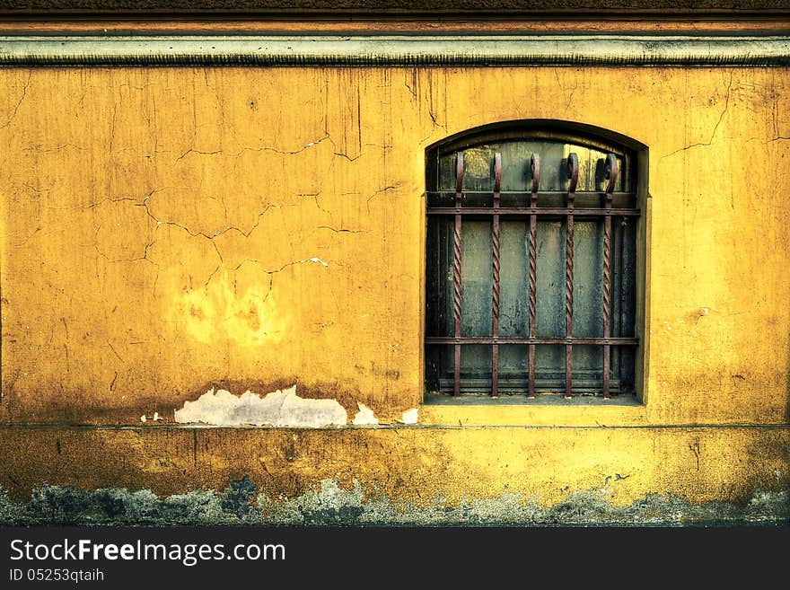 Dirty abandoned building facade wuth rusty bars