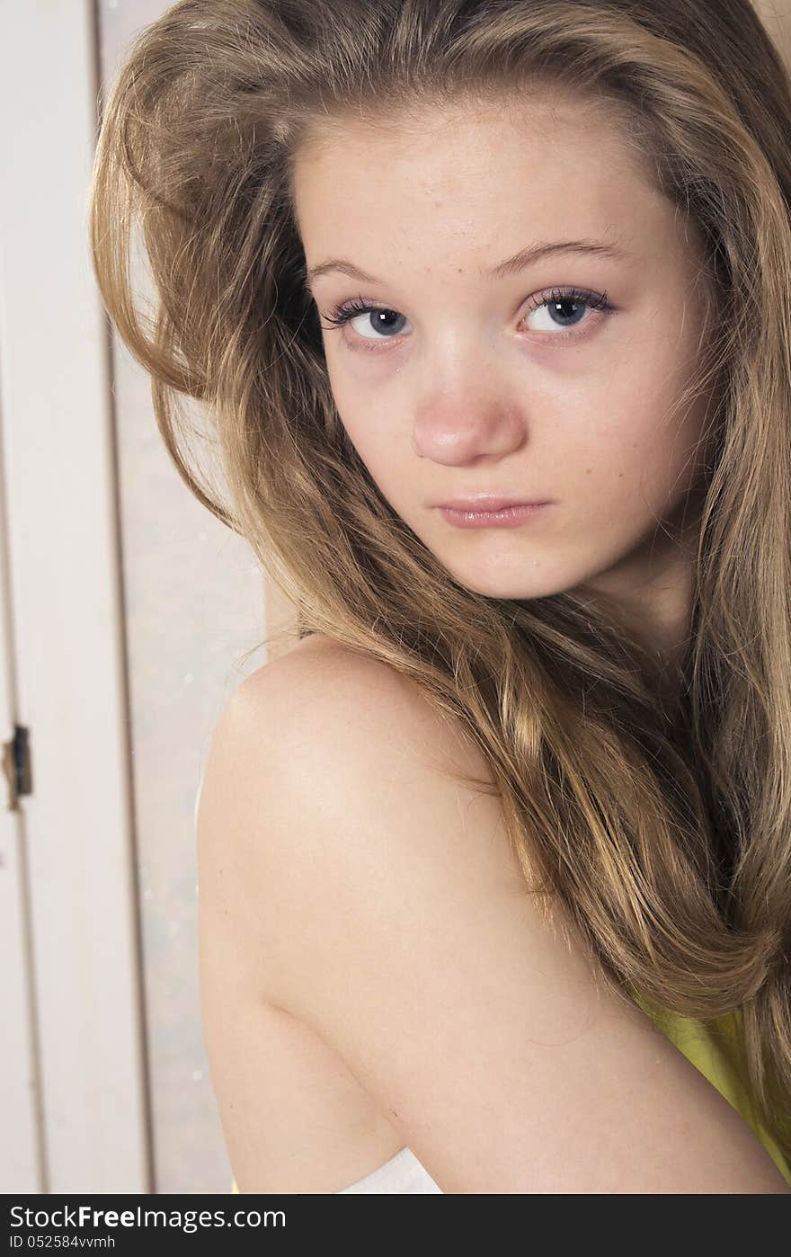 Teenage girl peeking out from wardrobe at home. Teenage girl peeking out from wardrobe at home