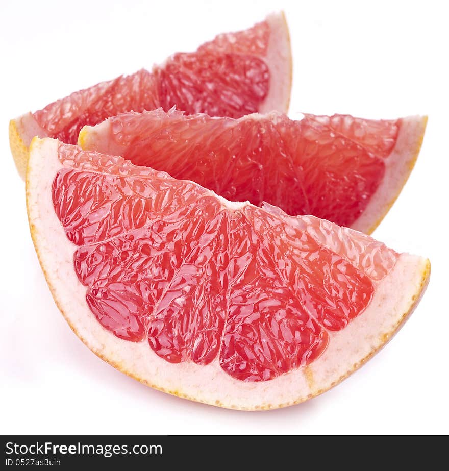 Slices of grapefruit on a white background. Slices of grapefruit on a white background.