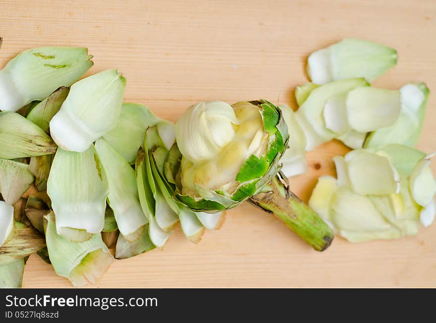 Cleaning artichoke for cooking on steam. Cleaning artichoke for cooking on steam