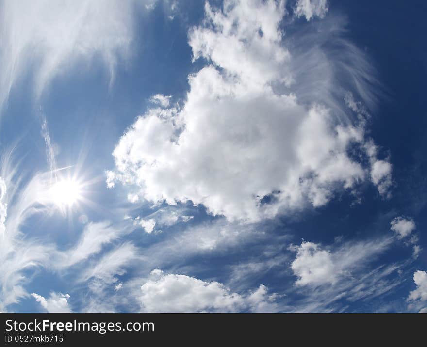 Blue sky with clouds and sun. Blue sky with clouds and sun.