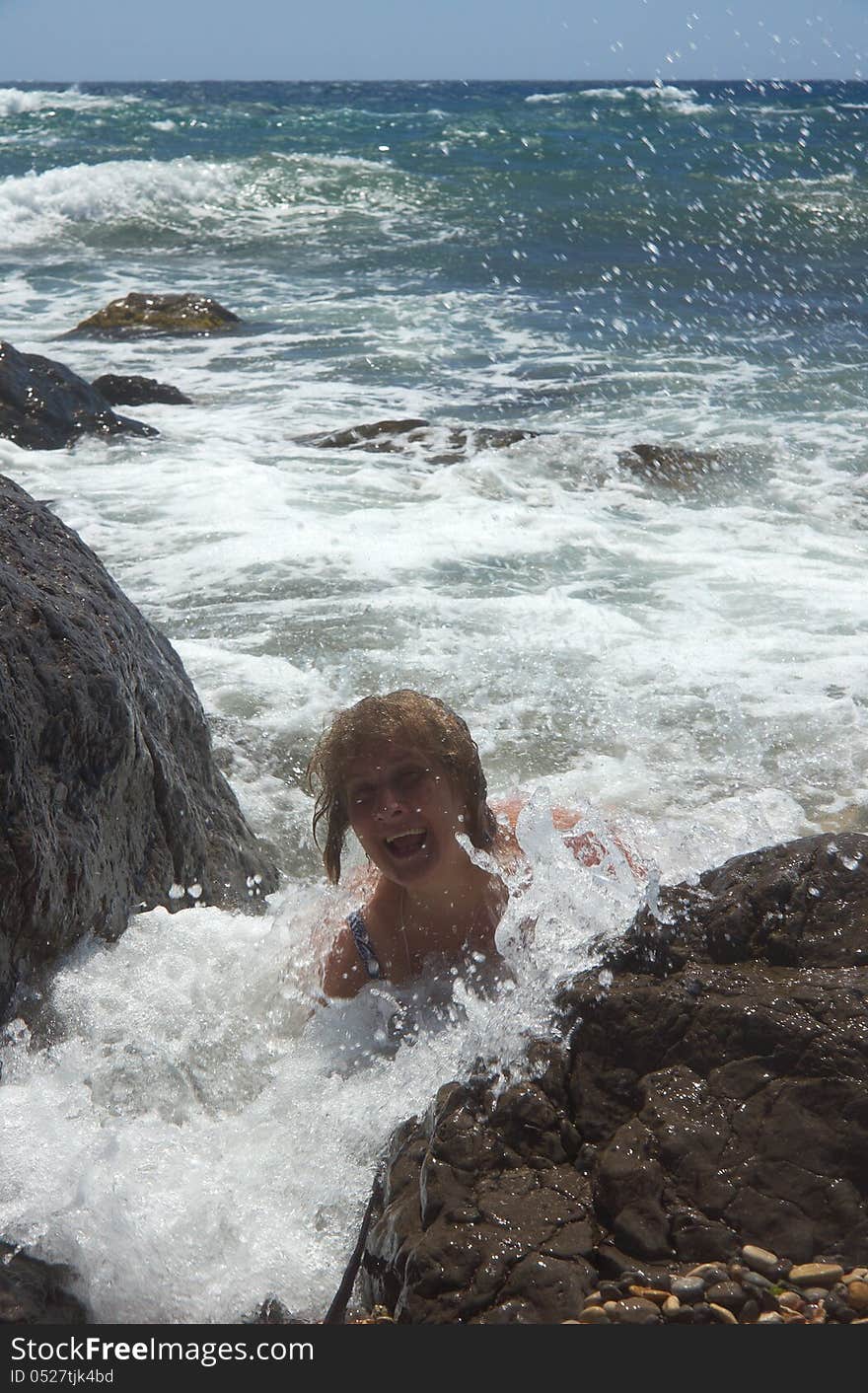 Senior smiling woman swimming in sea waves. Senior smiling woman swimming in sea waves