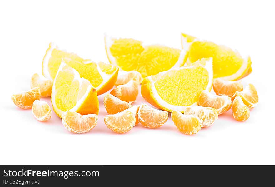 Mandarin and orange on a white background, fruit slices, shallow depth of field. Mandarin and orange on a white background, fruit slices, shallow depth of field