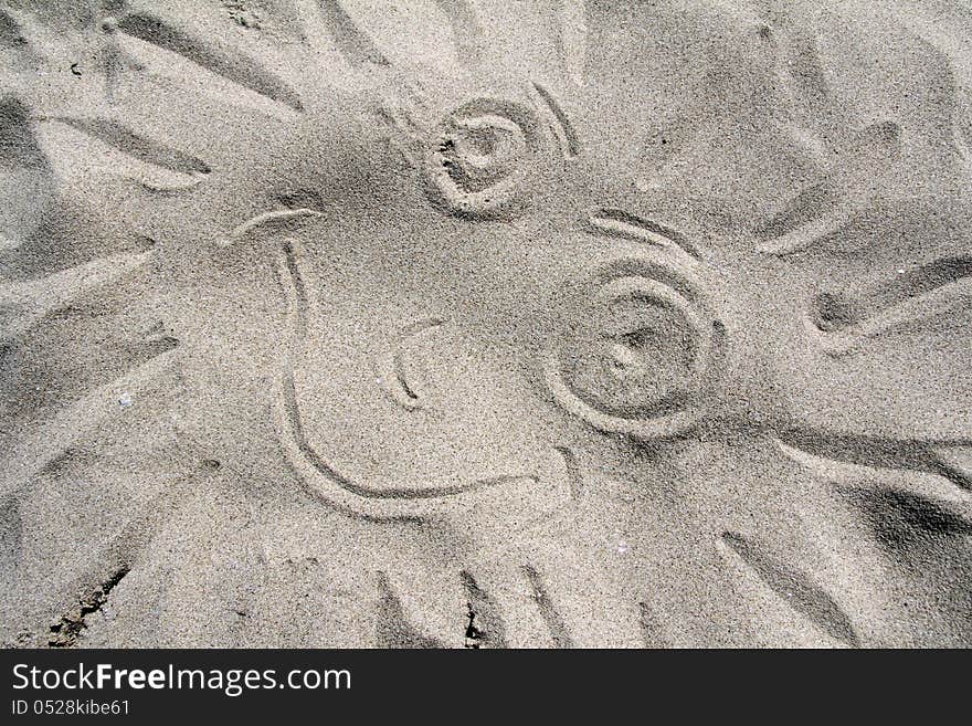 A sign of good mood on the sandy beach on a sunny day. A sign of good mood on the sandy beach on a sunny day