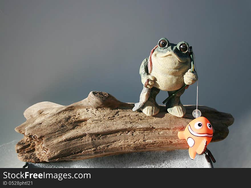 Ceramic frog fishing in a bucket of suds. Ceramic frog fishing in a bucket of suds.