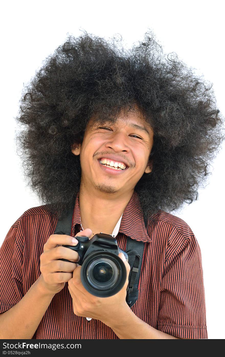 Smiling young man with long hair and holding digital camera. Smiling young man with long hair and holding digital camera