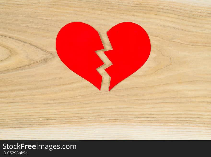 Beautiful broken heart on the background of wood