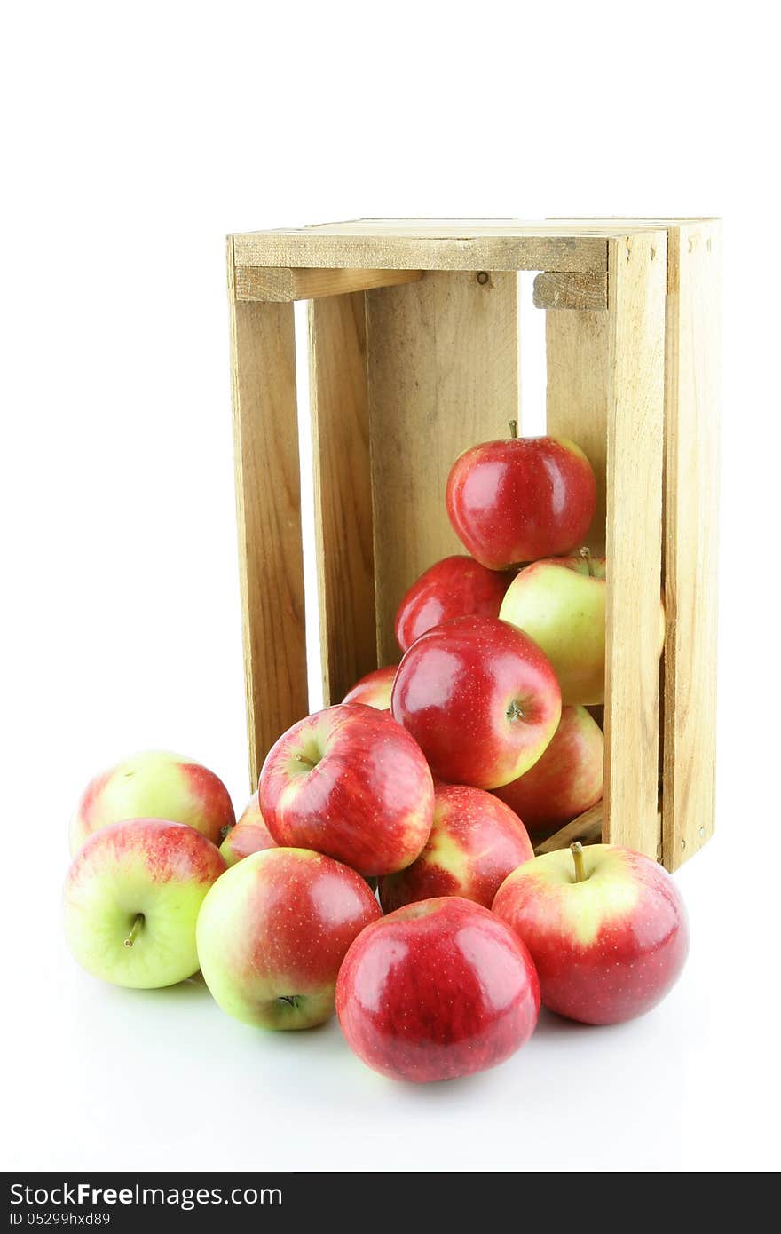 Red Elstar apples in a wooden crate, on a white background. Red Elstar apples in a wooden crate, on a white background.