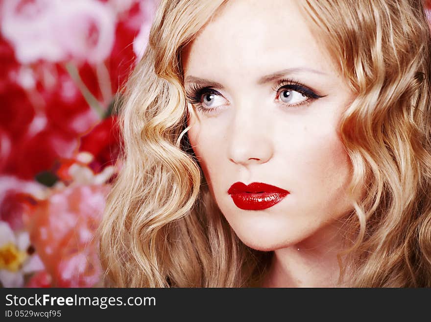 Beautiful Fashion Girl with red makeup and Roses.