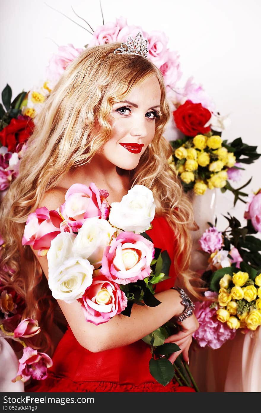 Beautiful Fashion Girl with red makeup and Roses. Hairstyle