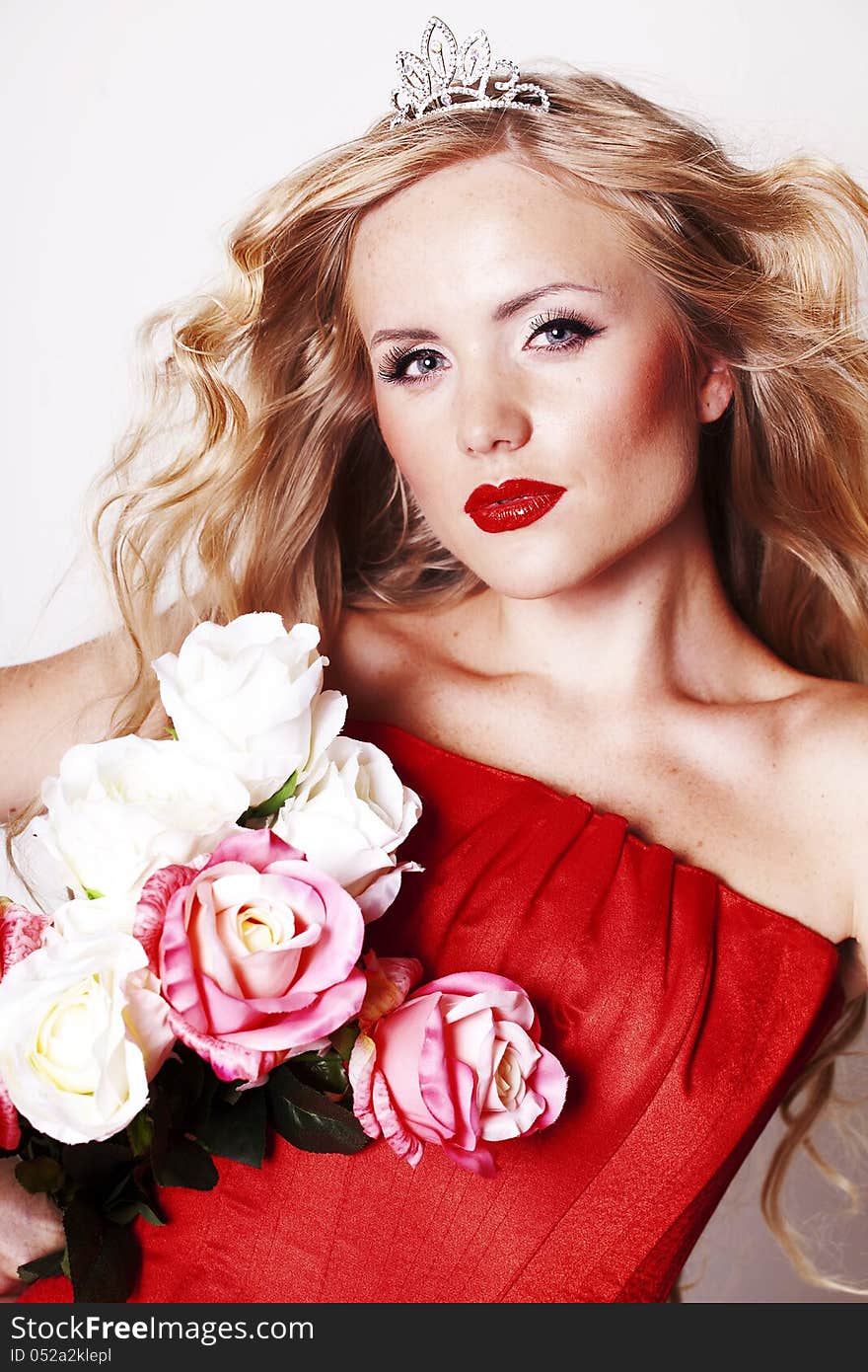 Beautiful Fashion Girl with red makeup and Roses. Hairstyle