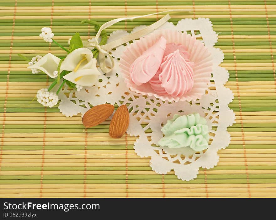 Sweet cream candies with white flowers on the napkin. Sweet cream candies with white flowers on the napkin