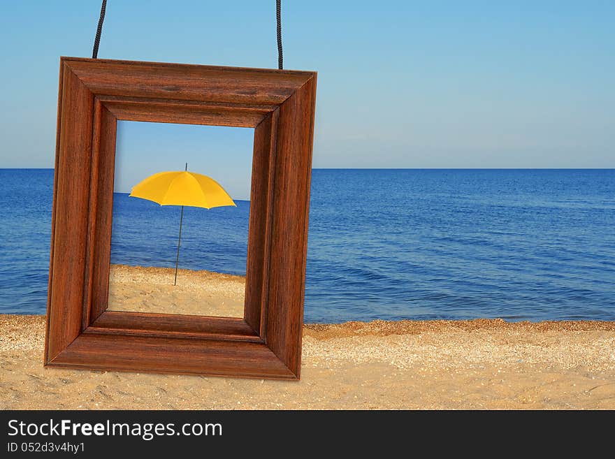 Beach umbrella and photographic frame on the beach