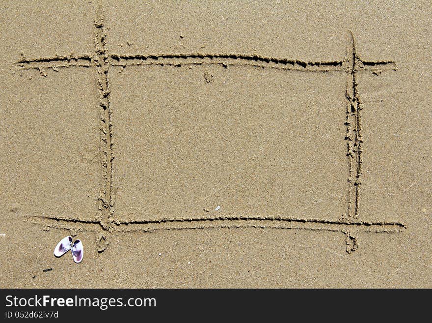 Empty frame drawn on the sand of the sea in summer. Empty frame drawn on the sand of the sea in summer