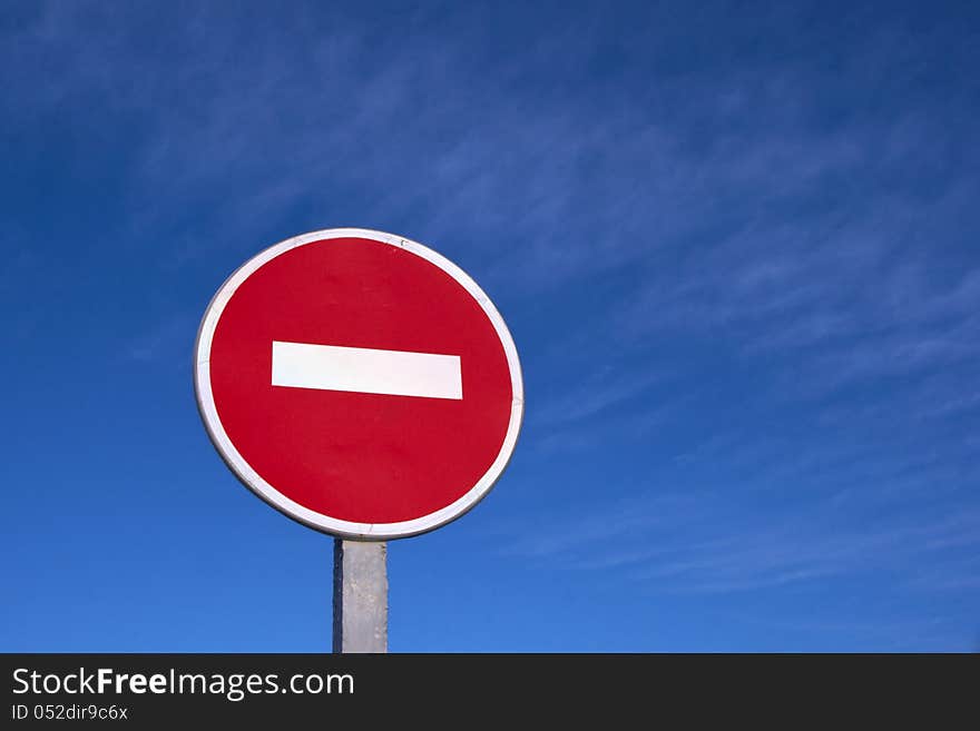 Road stop sign against clear deep blue sky