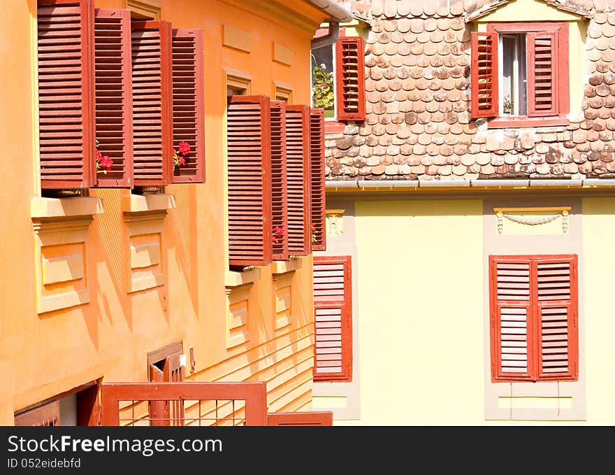 Old red windows with red flowers